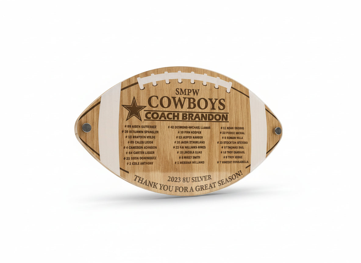 Wooden plaque shaped like a football with engraved text on a wooden background